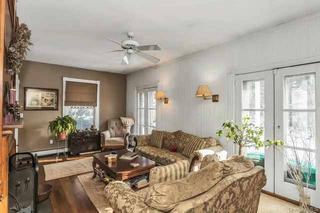 a living room with furniture chess table and a window