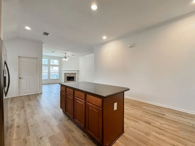 a kitchen with stainless steel appliances granite countertop a stove and a refrigerator