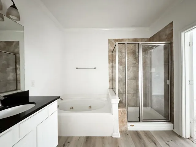 a bathroom with a bathtub and a shower