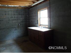 28 Spring Lane Clyde, NC 28721 - Photo 19 of 20 a bathroom with a sink and mirror