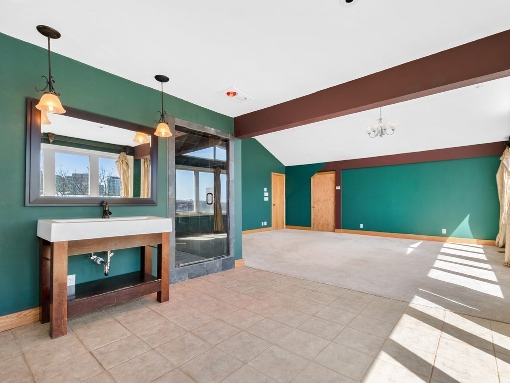 16 Putnam Road Somerville, MA 02145 - Photo 11 of 23 a bedroom with a bed and a large window