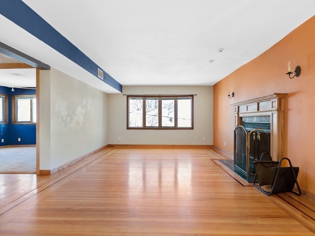 16 Putnam Road Somerville, MA 02145 - Photo 3 of 23 a view of an empty room with window and wooden floor