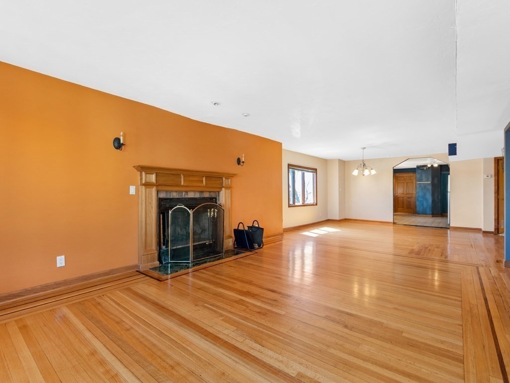16 Putnam Road Somerville, MA 02145 - Photo 4 of 23 a view of a livingroom with wooden floor and a fireplace