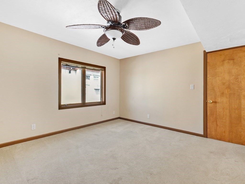 16 Putnam Road Somerville, MA 02145 - Photo 7 of 23 an empty room with windows and fan
