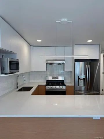 a kitchen with a refrigerator and a sink