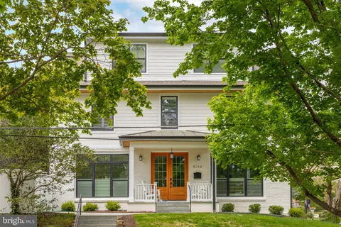 a front view of a house with a iron gate