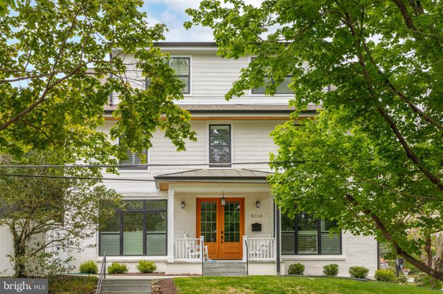 a front view of a house with a iron gate