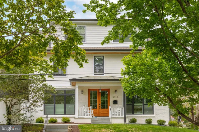 a front view of a house with a iron gate