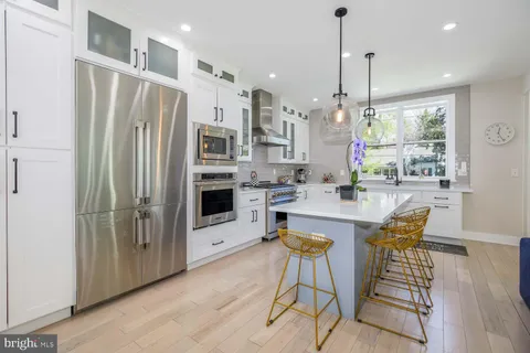 a view of a hallway with wooden floor and furniture