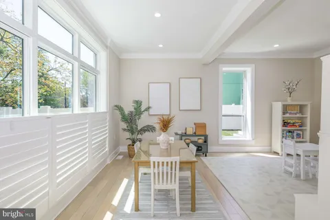a living room with furniture and a book shelf