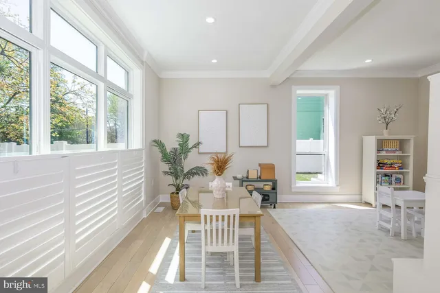 a living room with furniture and a book shelf
