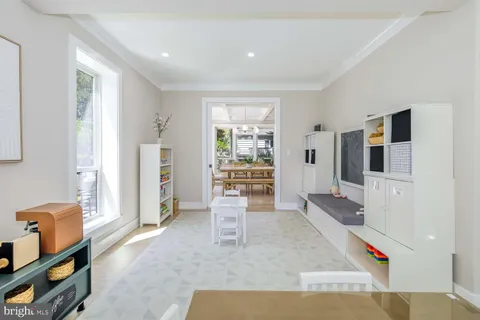a dining room with furniture a chandelier and wooden floor
