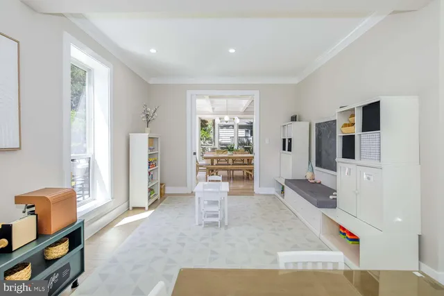 a dining room with furniture a chandelier and wooden floor