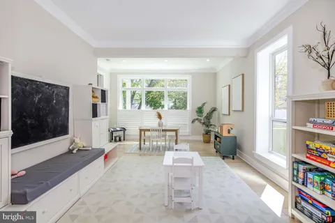 a dining room with wooden floor a chandelier a wooden table and chairs