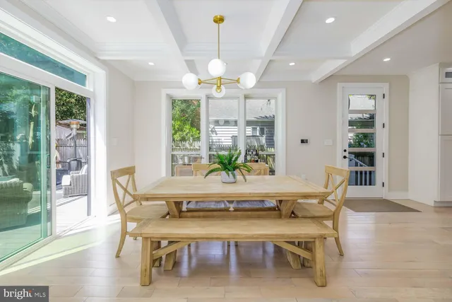 a view of a deck with couches table and chairs and wooden floor