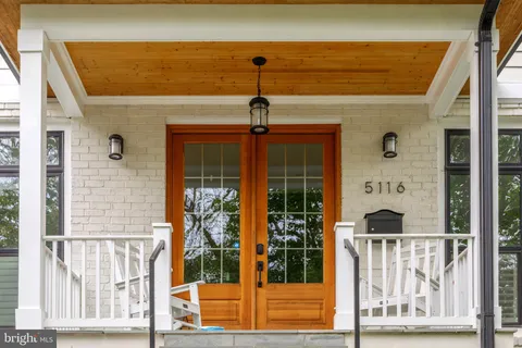 a living room with furniture large window and flat screen tv