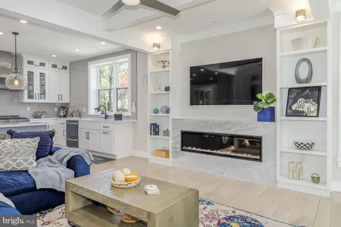 a kitchen with stainless steel appliances kitchen island granite countertop a sink and white cabinets