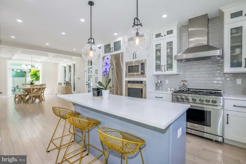 a kitchen with a stove a sink and a window