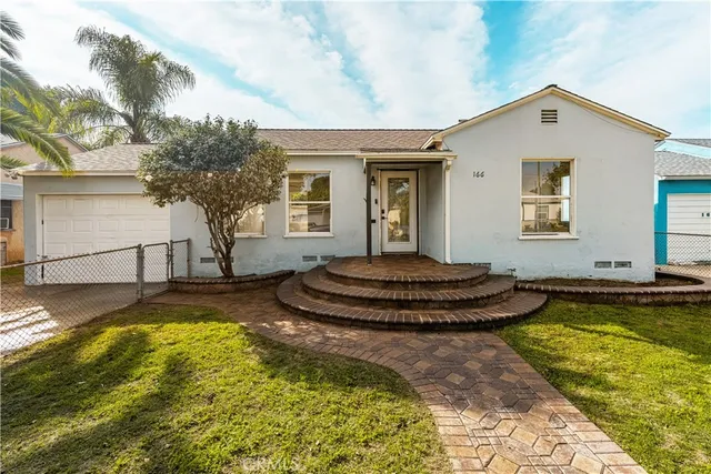 a view of a house with swimming pool and sitting area