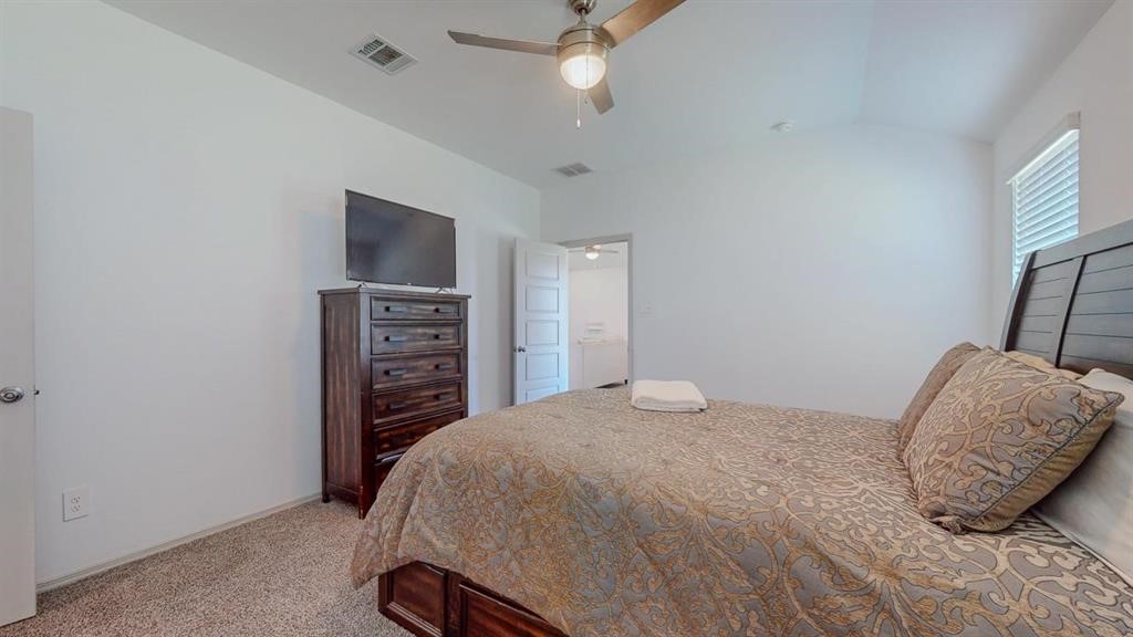6710 Riplee Street Beaumont, TX 77708 - Photo 14 of 27 a bedroom with a bed and a television