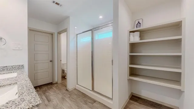 a view of a hallway with wooden floor and entryway