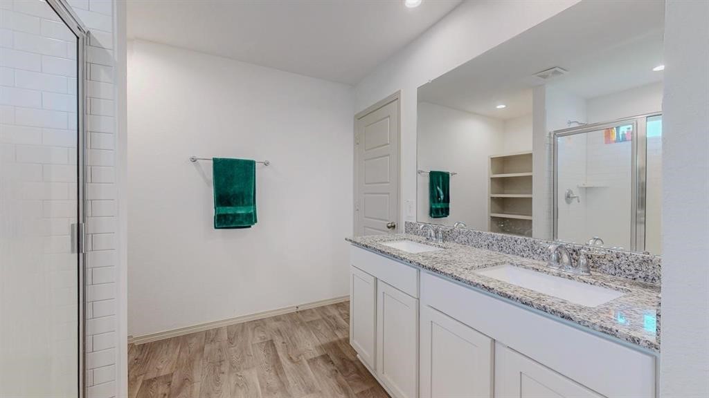 6710 Riplee Street Beaumont, TX 77708 - Photo 18 of 27 a bathroom with a granite countertop sink and a mirror