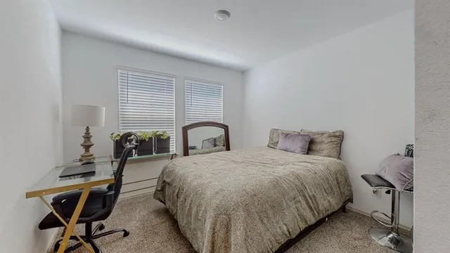 a bedroom with a bed and a table