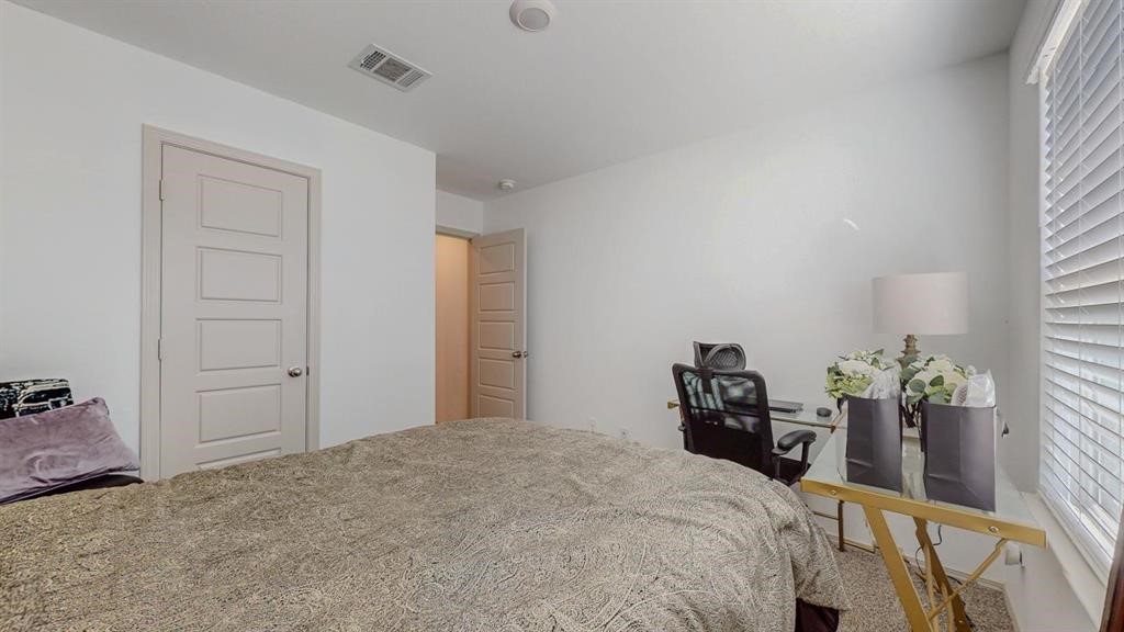 6710 Riplee Street Beaumont, TX 77708 - Photo 20 of 27 a bedroom with a bed and a table