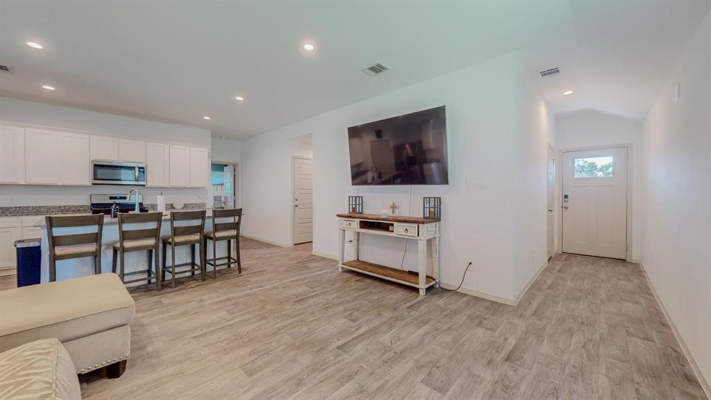 6710 Riplee Street Beaumont, TX 77708 - Photo 2 of 27 a living room with furniture and a flat screen tv