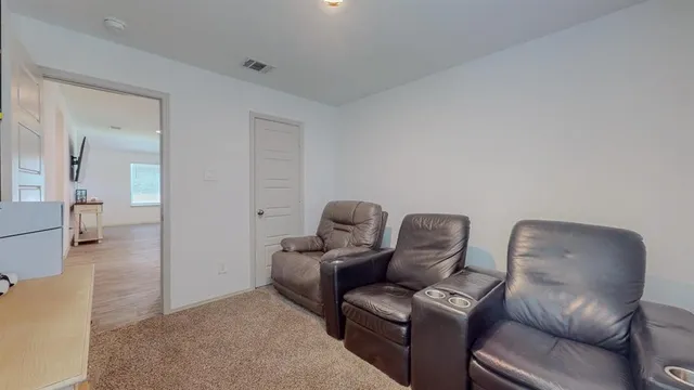 a view of a patio with table and chairs and potted plants with wooden floor and fence