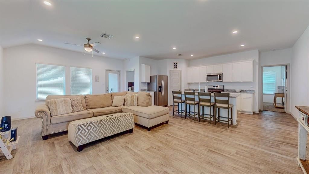 6710 Riplee Street Beaumont, TX 77708 - Photo 3 of 27 a living room with furniture and kitchen view with wooden floor