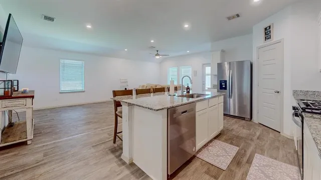 a kitchen with a sink stove and refrigerator