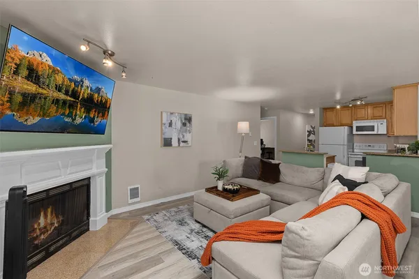 a living room with furniture a fireplace and a flat screen tv
