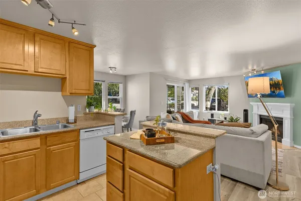 a kitchen with sink cabinets and living room