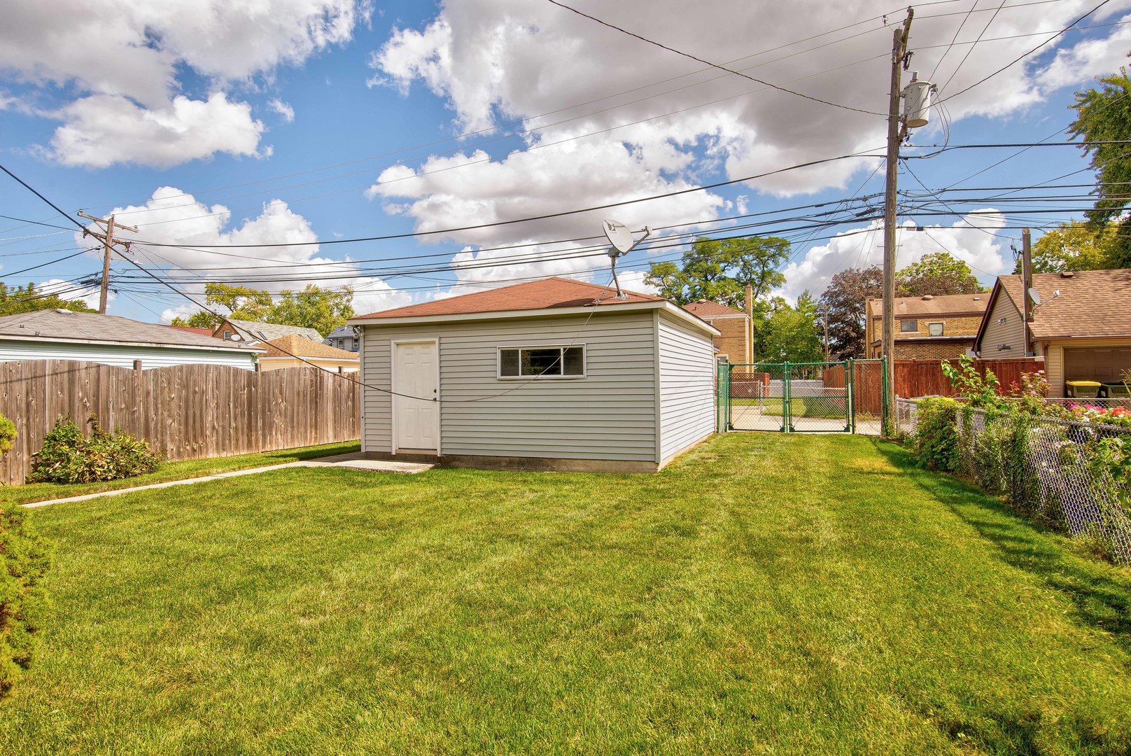 2441 Clarke Street River Grove, IL 60171 - Photo 21 of 25 a backyard of a house with a garden and outdoor seating