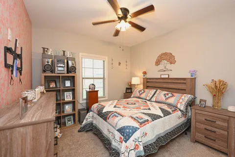 a living room with furniture a chandelier and a flat screen tv