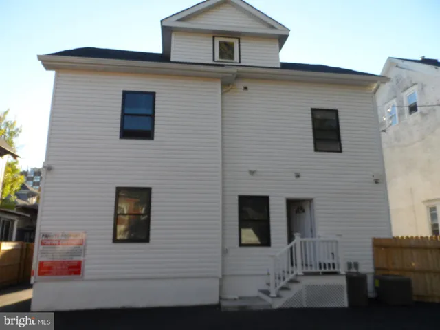 a kitchen with kitchen island granite countertop a sink dishwasher stove and cabinets