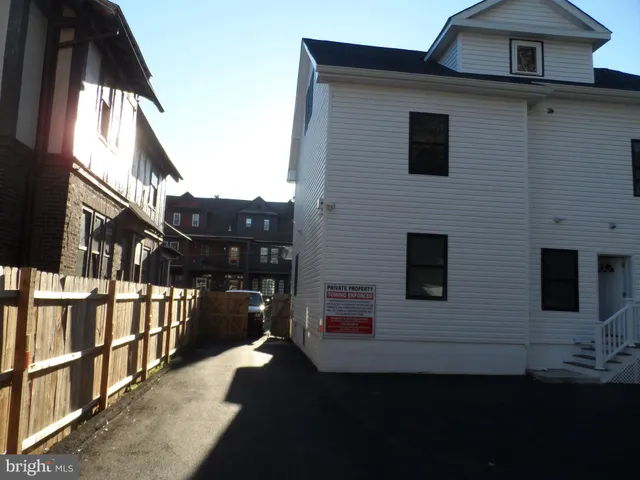 a living room with furniture and a air conditioner vent