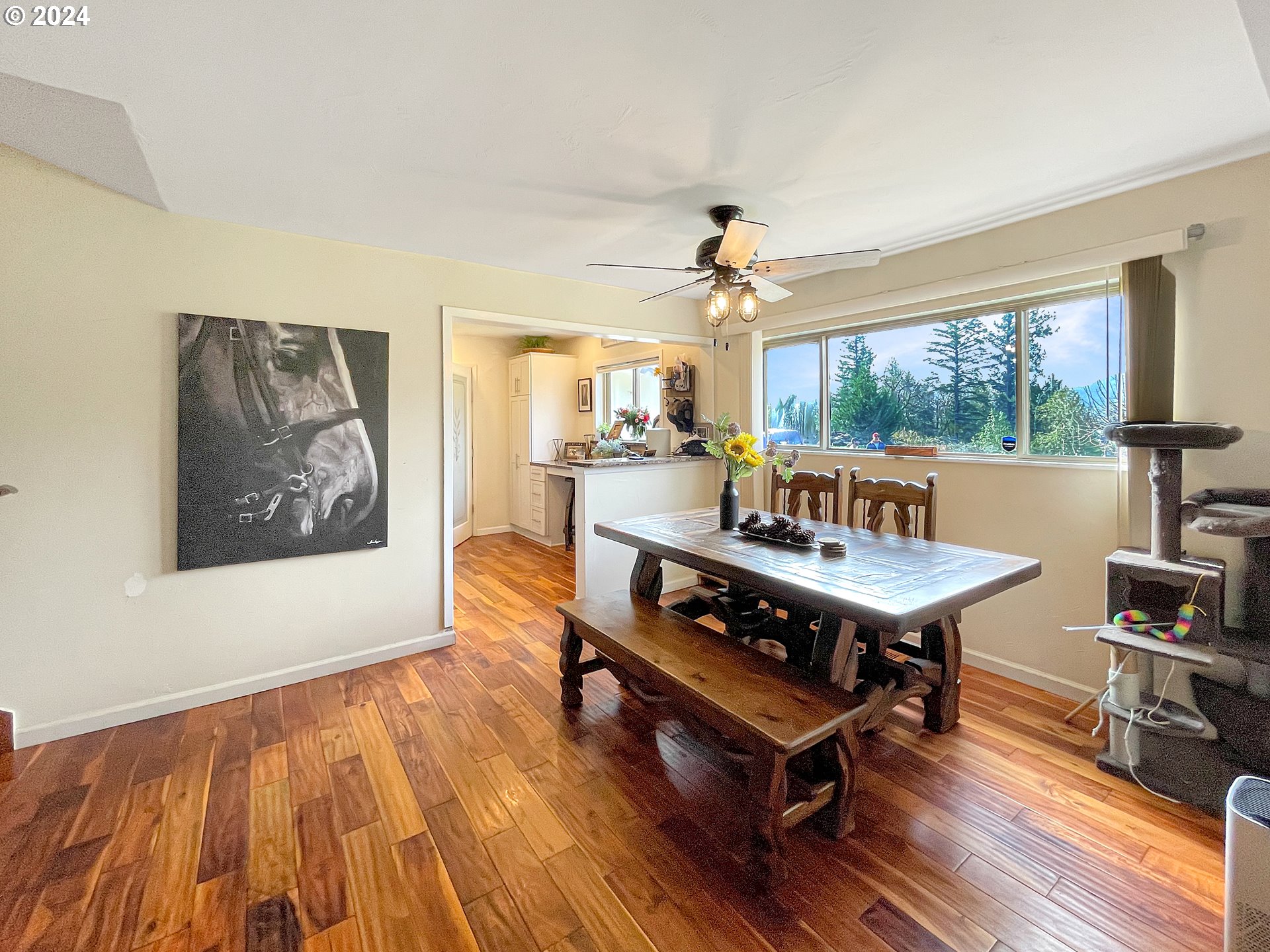 17676 Gardner Ridge Road Brookings, OR 97415 - Photo 13 of 42 a view of a dining room with furniture window and wooden floor