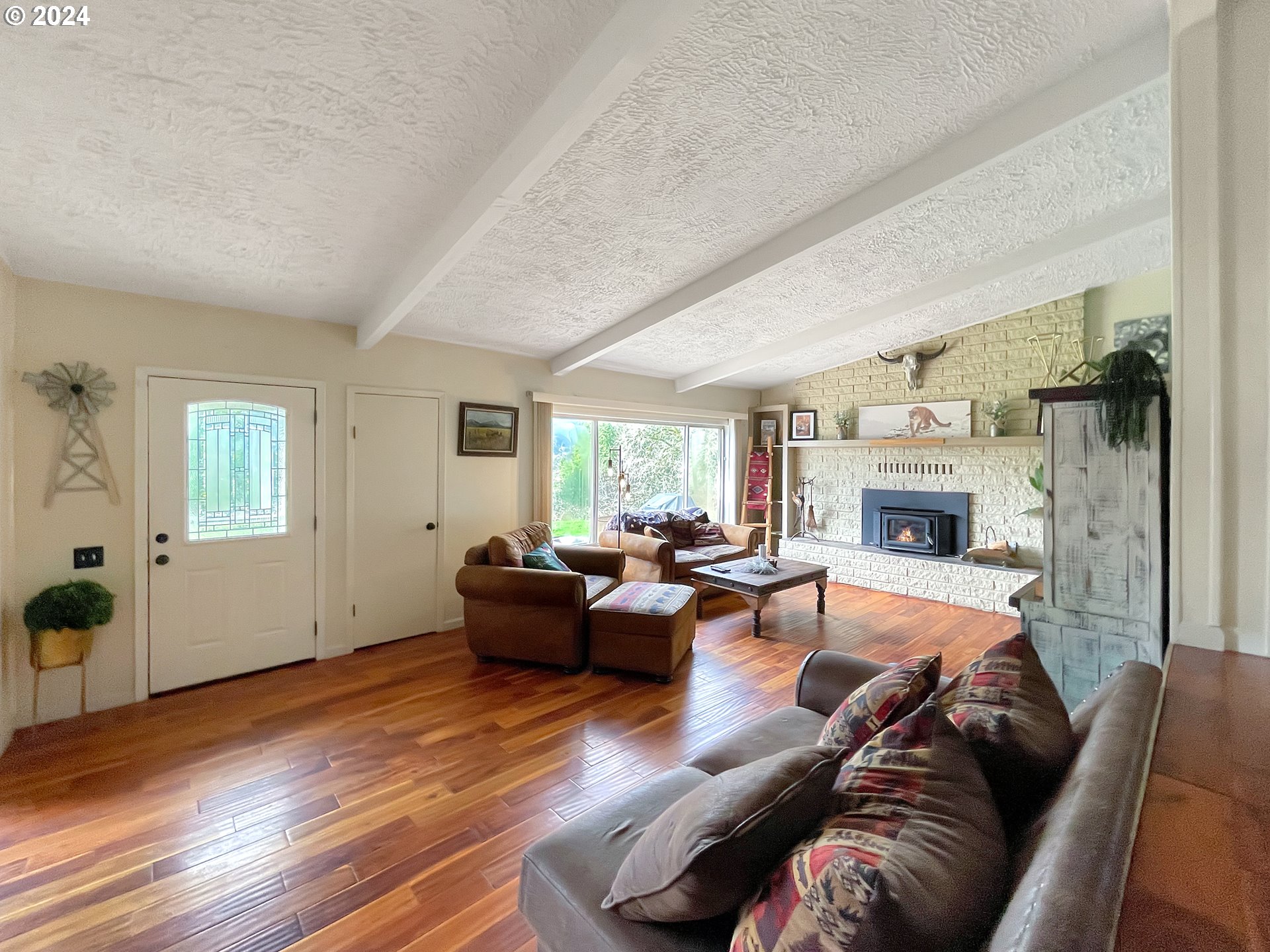 17676 Gardner Ridge Road Brookings, OR 97415 - Photo 16 of 42 a living room with furniture and a fireplace