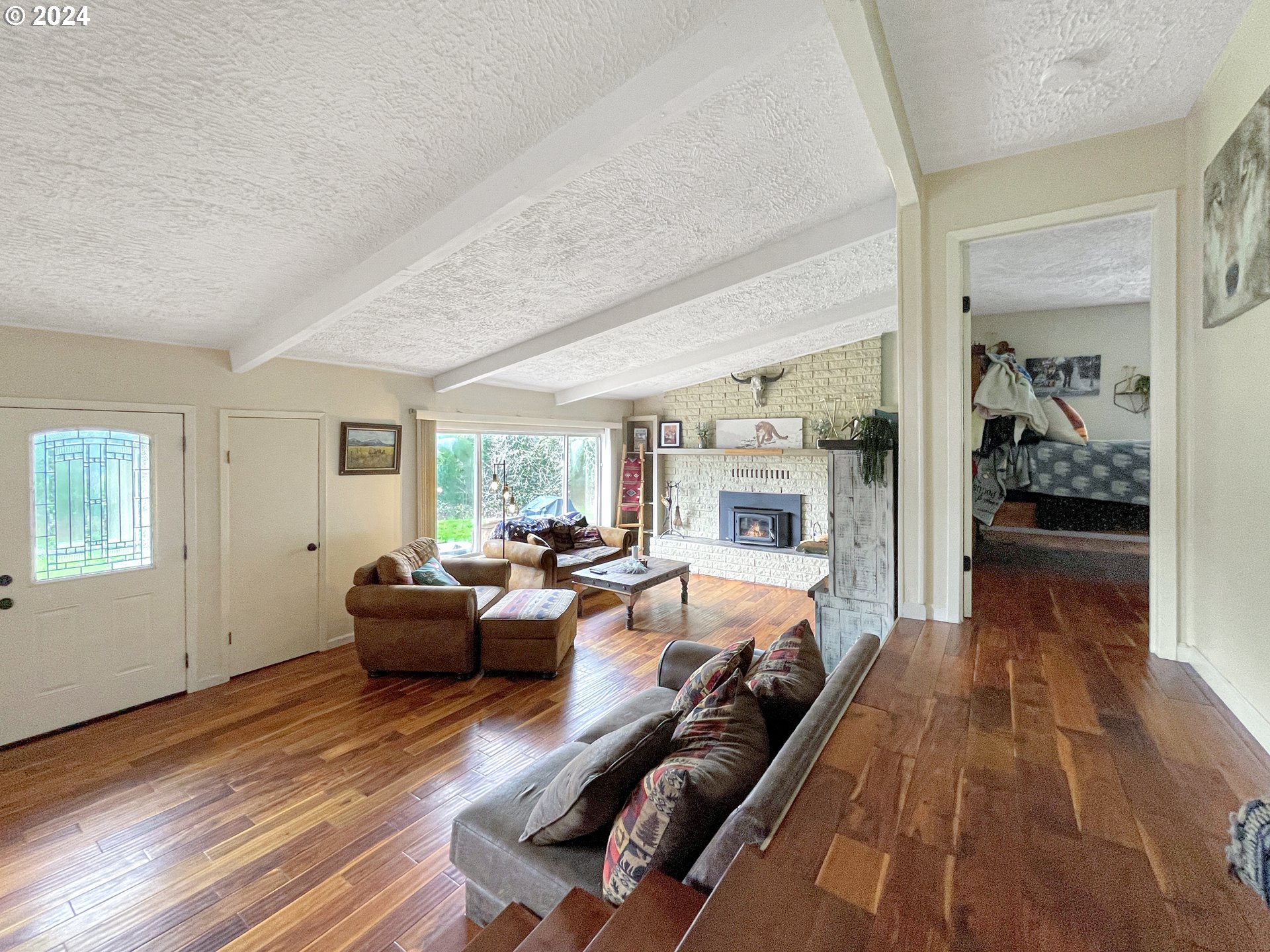 17676 Gardner Ridge Road Brookings, OR 97415 - Photo 17 of 42 a living room with furniture and a wooden floor