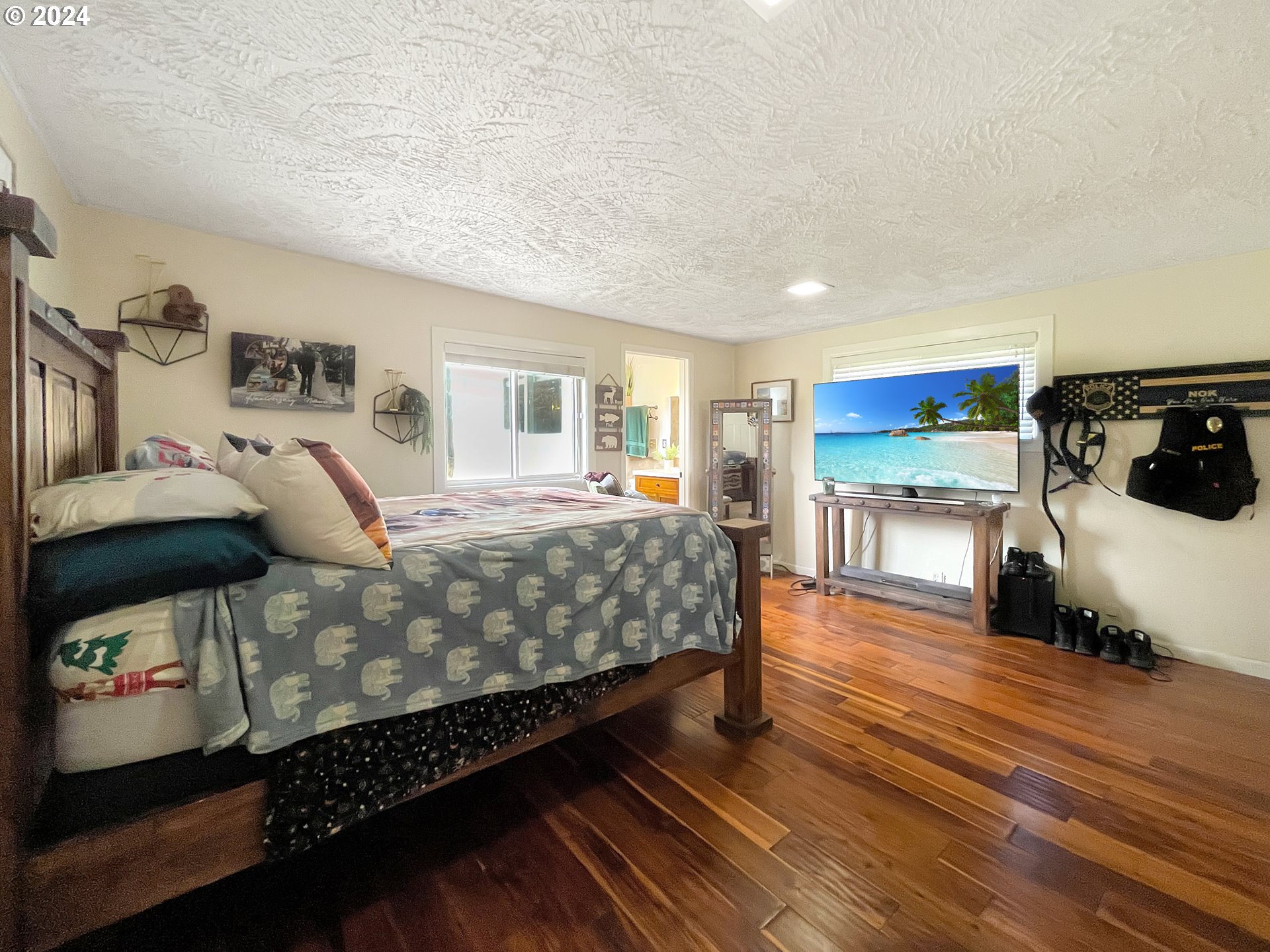 17676 Gardner Ridge Road Brookings, OR 97415 - Photo 20 of 42 a bedroom with a bed and wooden floor