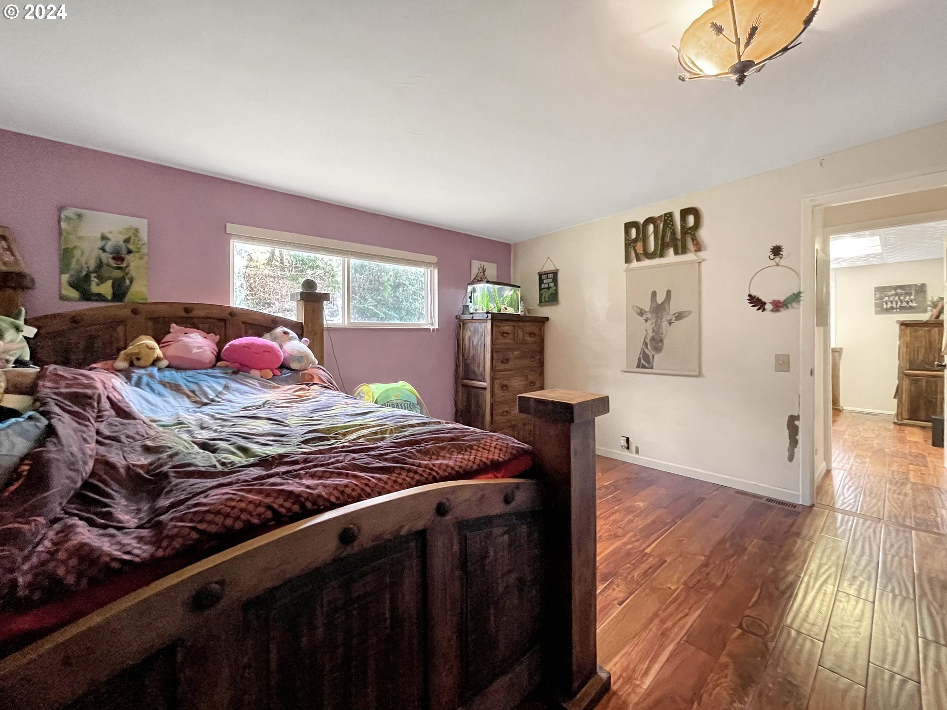 17676 Gardner Ridge Road Brookings, OR 97415 - Photo 25 of 42 a bedroom with a bed and wooden floor