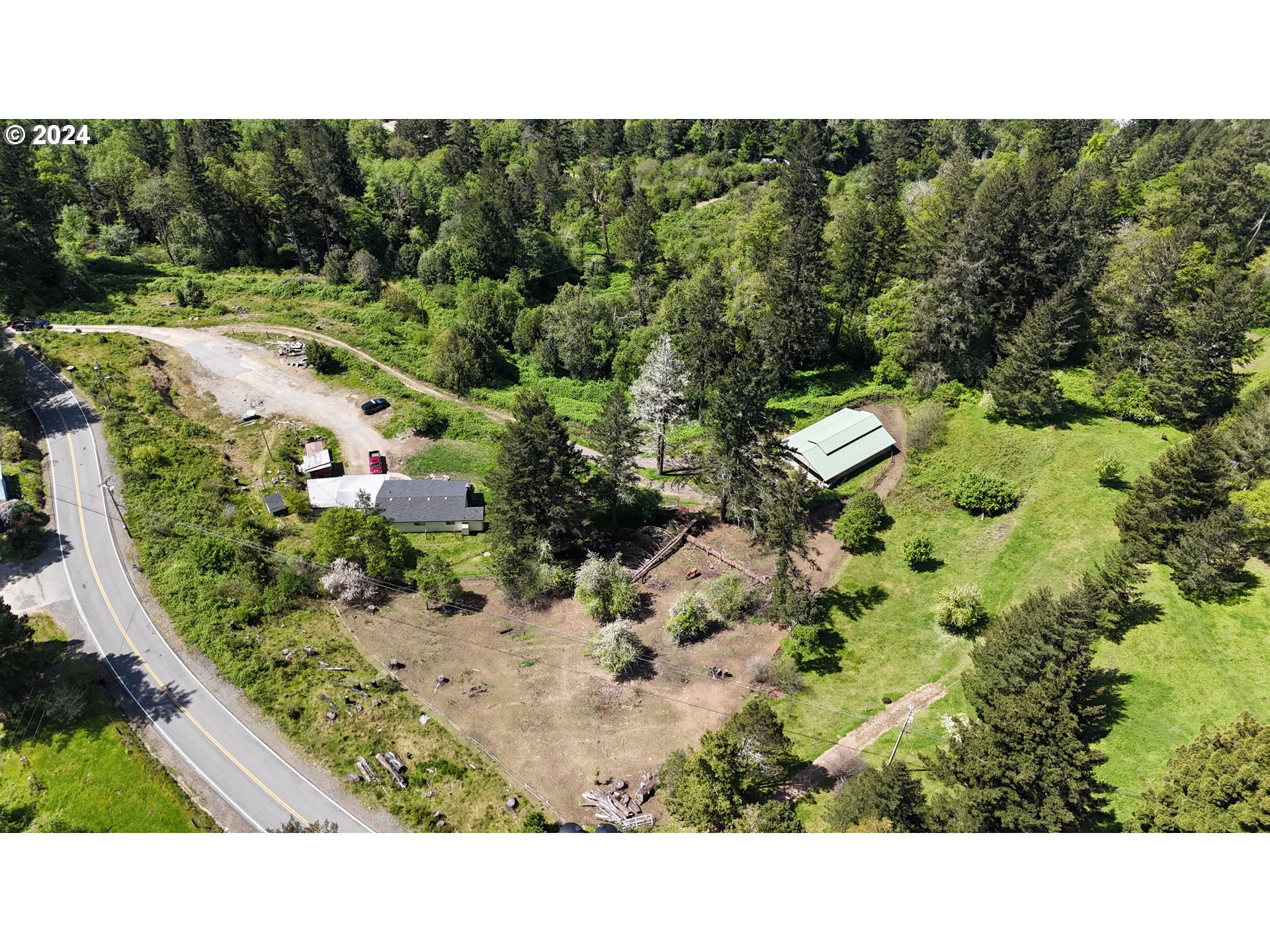 17676 Gardner Ridge Road Brookings, OR 97415 - Photo 41 of 42 a view of a garden with a tree