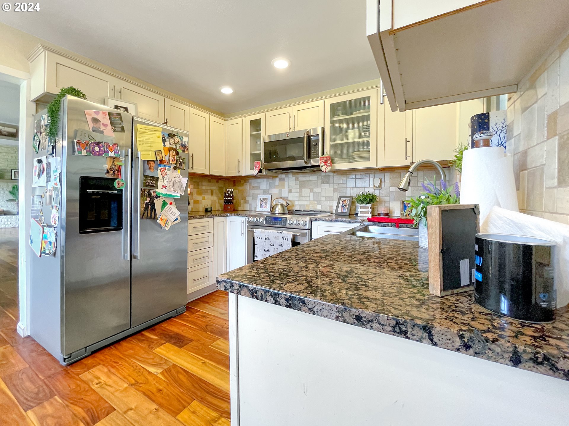 17676 Gardner Ridge Road Brookings, OR 97415 - Photo 5 of 42 a kitchen with stainless steel appliances granite countertop a refrigerator a sink and a stove