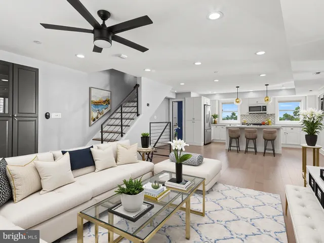 a living room with lots of furniture and kitchen view