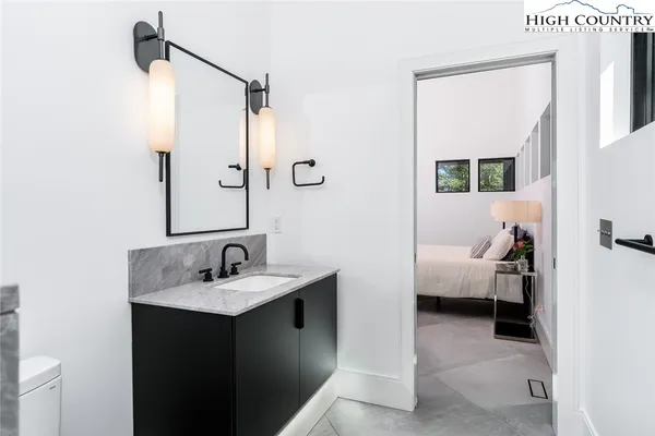 a bathroom with a toilet a sink and mirror