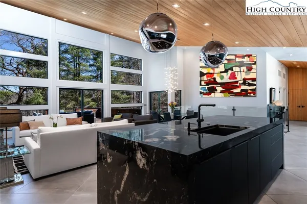 a kitchen with granite countertop a sink and a stove top oven
