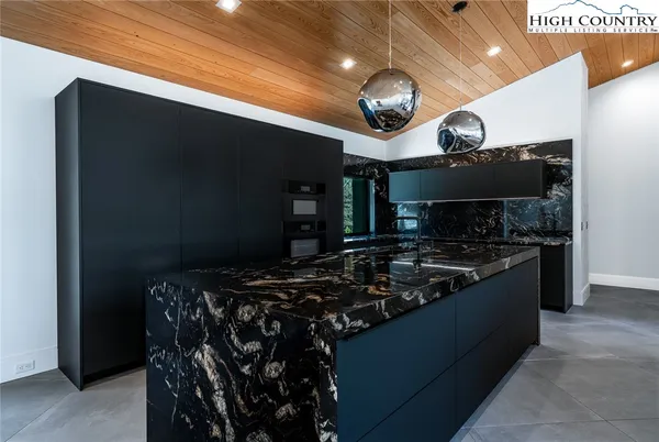 a kitchen with stainless steel appliances granite countertop a stove and a microwave