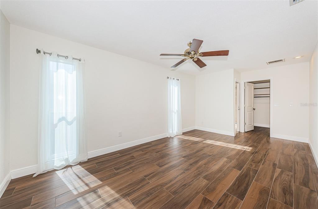 4723 114th Street North Madeira Beach, FL 33708 - Photo 22 of 41 a view of empty room with wooden floor and fan